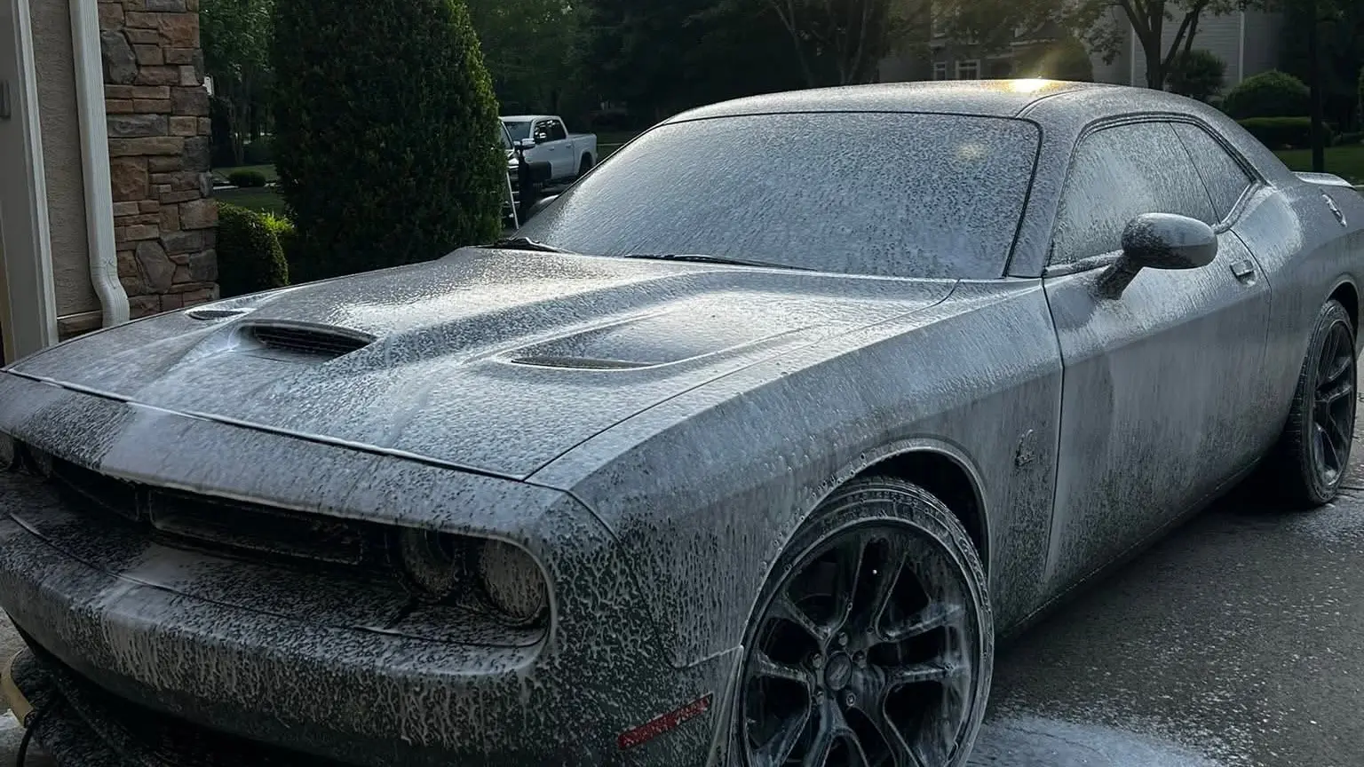 Brothers Detailing foam-washing a Dodge Challenger in a Waxhaw driveway